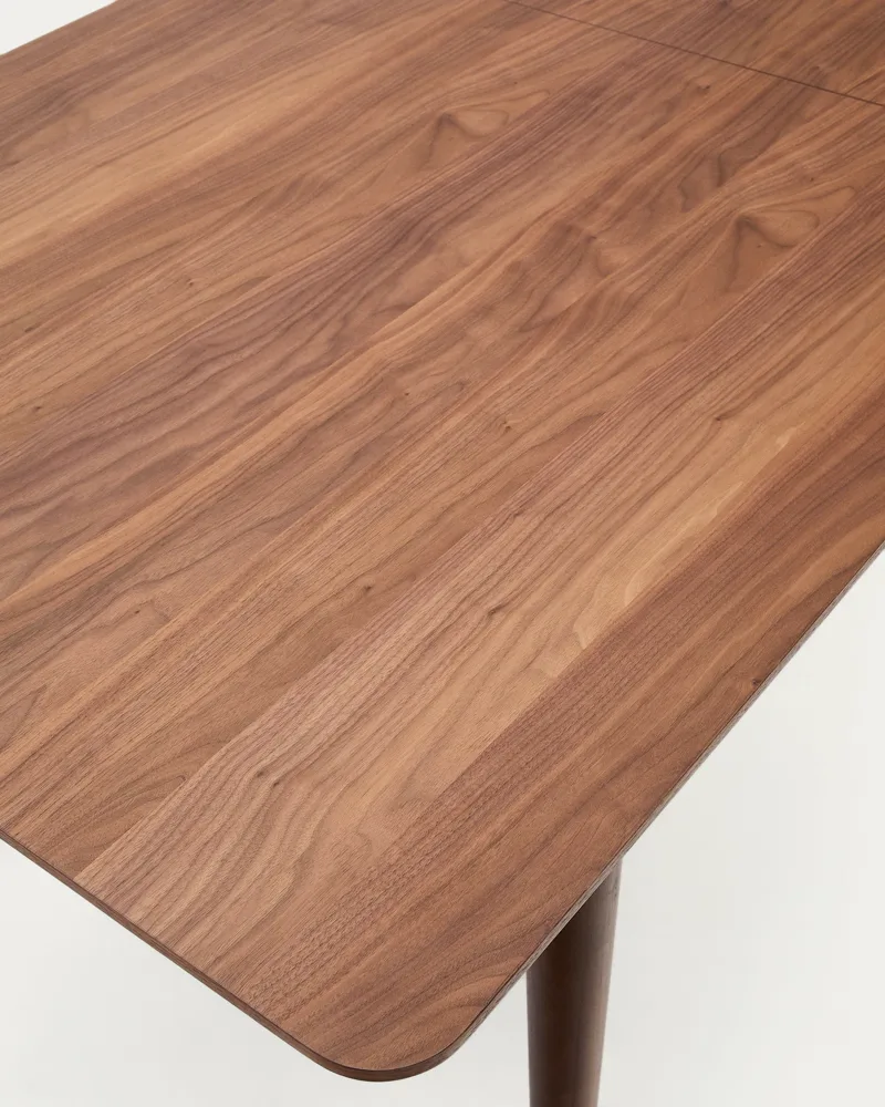 Détail du plateau plaqué noyer et du piètement en bois de noyer de la table Elan